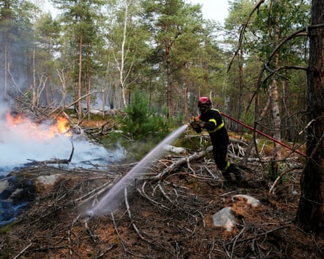 A firefighter operates during a fire in the Fontainebleau Forest, in Noisy-sur-Ecole, in the Paris’ Ile-de-France region.