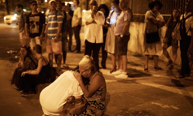 People react at the scene where Marielle Franco and her driver have were shot to death in Rio de Janeiro, Brazil, on 15 March. Police believe militias were involved.