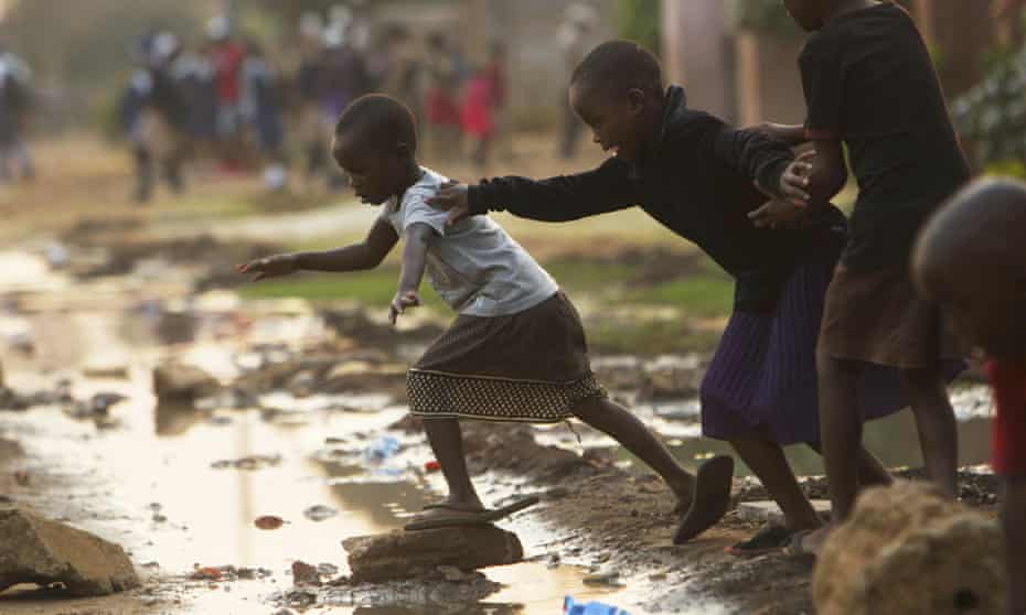 Children jump over raw flowing sewage on the streets of Harare, Zimbabwe, amid a cholera outbreak in the country which has killed at least 30 people.