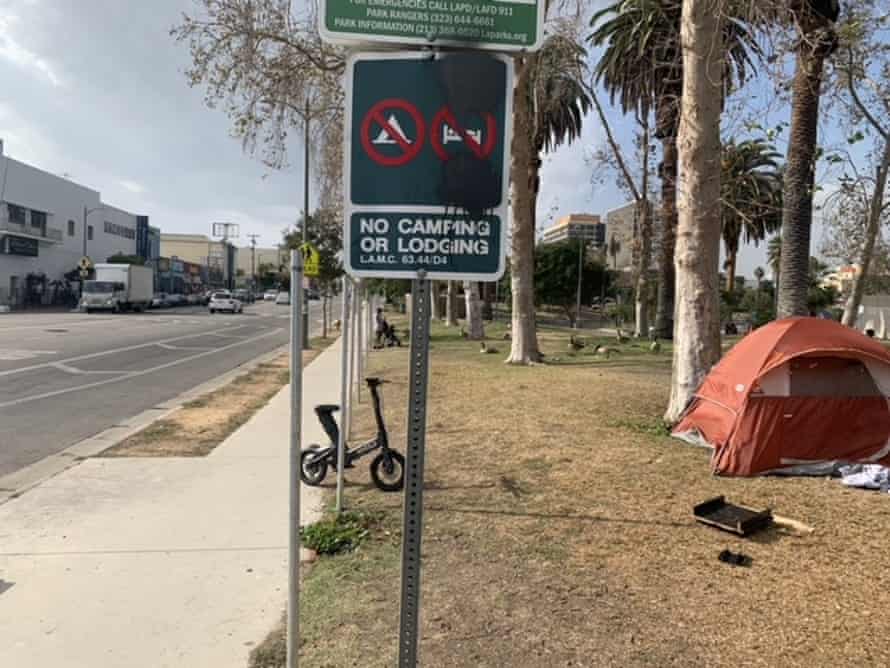 A tent has been placed near a ‘No camping’ sign at MacArthur Park in Los Angeles.