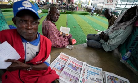A vendor sells local newspapers in Lagos on Thursday.