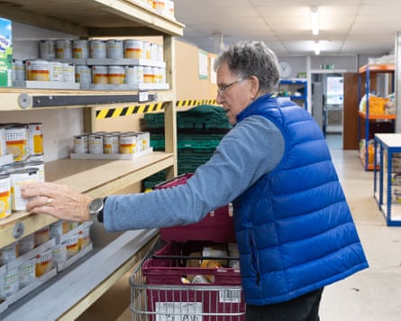 A volunteer stacking cans at Whitstable food bank