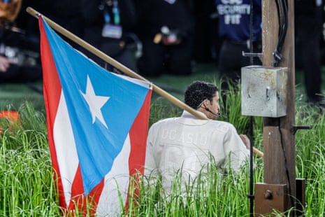 Bad Bunny holds the Puerto Rican flag while he performs during the Super Bowl.