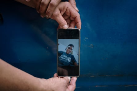 Yorluis Betancourt holds his mother’s hands while she shows a picture of her detained son Alfredo Alejandro Rondón in her cellphone near the detention centre Zona 7 in Caracas on Thursday.