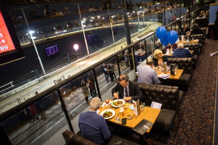 People dine in the Grandstand restaurant.