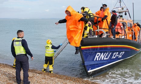 A group of people thought to be migrants are brought in to Dungeness beach by the Dungeness lifeboat following a small boat incident in the Channel. 