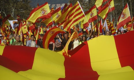 Nationalist activists protest with Spanish and Catalan flags during a mass rally against Catalonia’s declaration of independence, in Barcelona, Spain.