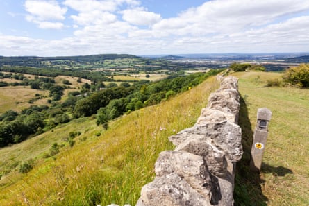 A view of a stone wall with Cotswolds countryside beyond