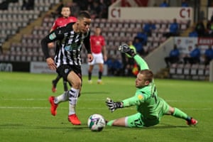 Miguel Almiron goes around Morecambe’s goalkeeper Mark Halstead on his way to scoring Newcastle’s second.