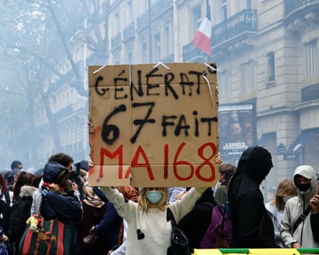 A protester holds a placard reading “Generation Six – Seven re-enacts May 68" behind a barricade to block the Boulevard Saint-Germain during a blockade of Sciences Po university in Paris, France.