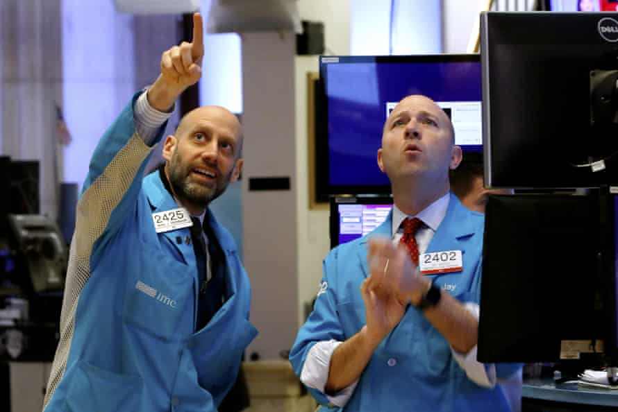 Specialists Meric Greenbaum, left, and Jay Woods work on the floor of the New York Stock Exchange today