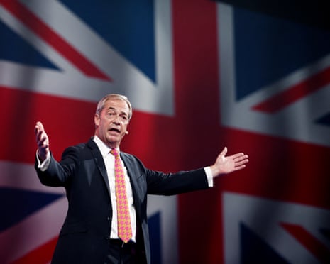 Nigel Farage on stage in front of giant projection of union flag