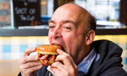 Phil Daoust eating a bacon-filled doughnut in 2015.
