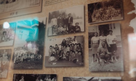 Old black and white photographs on the wall of a school.