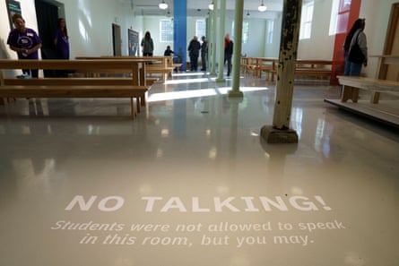 A message painted on the floor of the dining hall reads: ‘No talking!’