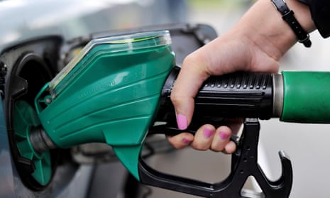 Close up of a person using a petrol pump