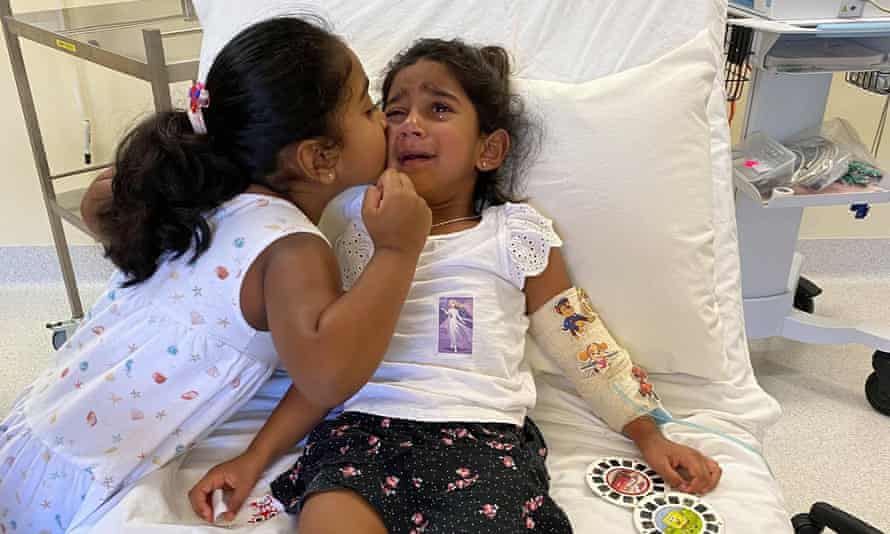 Tharnicaa Muruguppan being kissed by sister Kopica