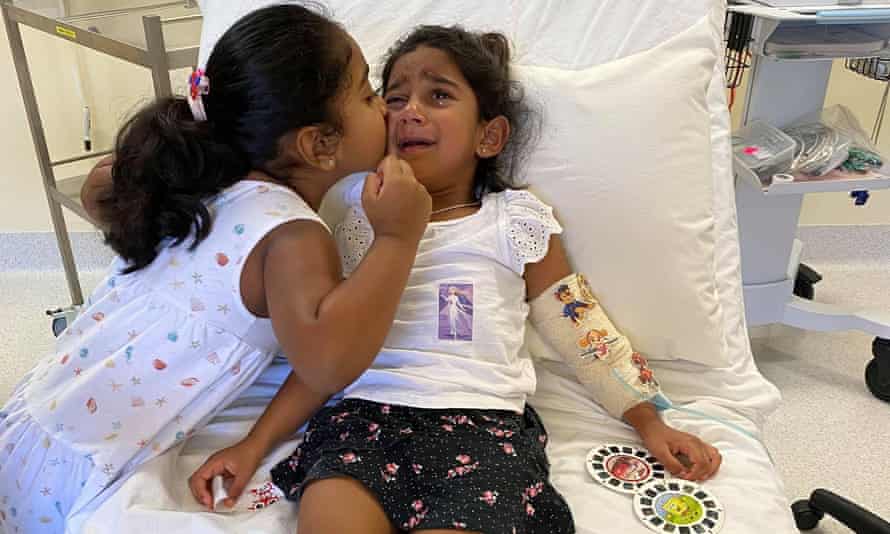 Kopika Murugappan comforts her three-year-old sister Tharnicaa