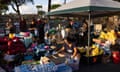 Volunteers sort out donations at a parking lot in Lahaina, for those affected by the wildfire in western Maui, Hawaii, on 12 August 2023.