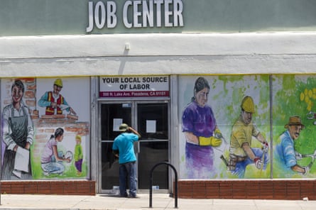 A man looks inside the closed doors of the Pasadena Community Job Center.