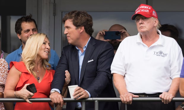 Donald Trump with Fox News’s Tucker Carlson and the congresswoman Marjorie Taylor Greene at the LIV Golf event at his Bedminster golf club last weekend.