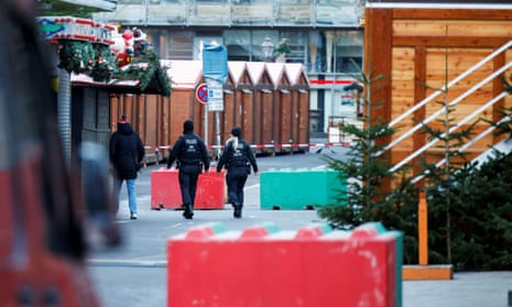 Green and red bollards aimed at preventing vehicles from entering the market.