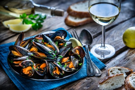 A plate of mussels and a glass of white wine