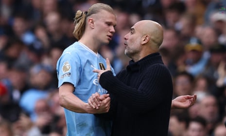Pep Guardiola speaks with Erling Haaland as he leaves the pitch angrily after being substituted during the Premier League football match between Manchester City and Wolves at the Etihad Stadium