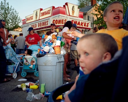 An overflowing rubbish bin at a fair in McArthur, Ohio, in 2004, with children and their parents all around