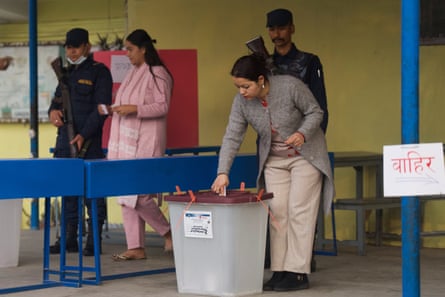 A woman casts her vote at a polling station.