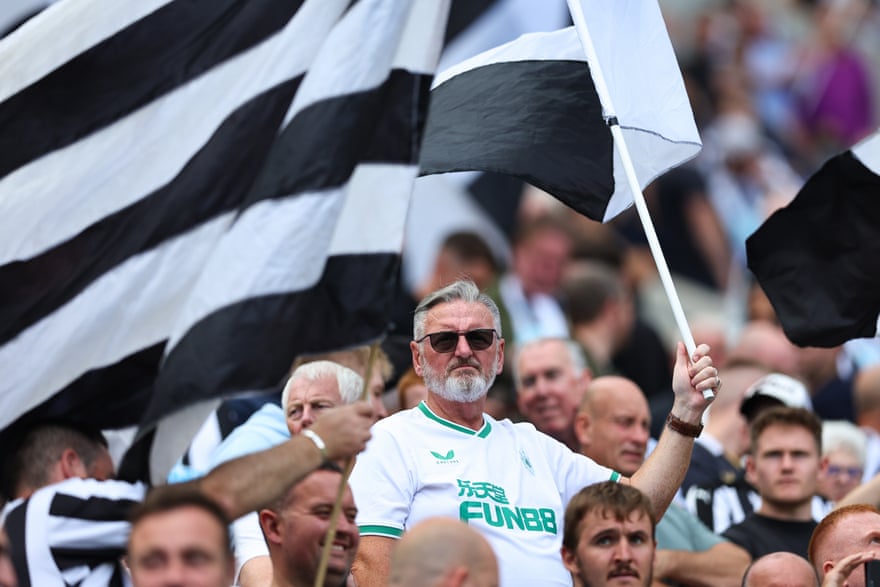 Newcastle fans wave a flag at St James' Park.