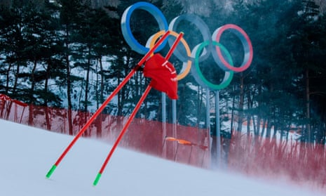 A gate flag flutters in the wind after the women’s giant slalom was postponed due to high winds.