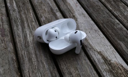The AirPods Pro 2 case pictured open on a table with one earbud hanging on the lid.