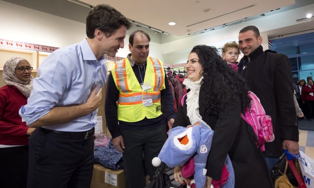 Justin Trudeau greets Syrian refugees Georgina Zires, center, Madeleine Jamkossian, second right, and her father Kevork Jamkossian in December.
