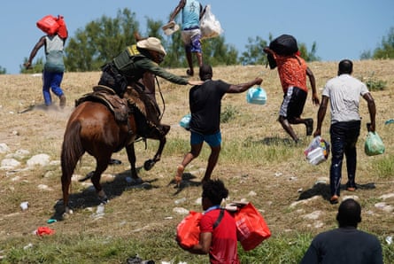 border patrol agent on horseback grabs migrant