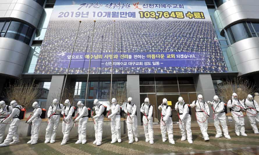 Soldiers spray disinfectant to prevent the spread of the coronavirus in front of a branch of the Shincheonji church of Jesus in Daegu, South Korea