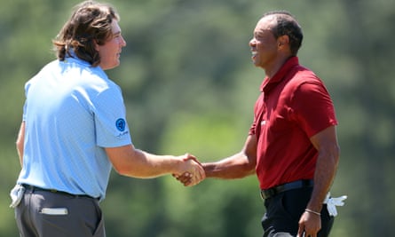 The amateur Neal Shipley and Tiger Woods shake hands on the 18th green after finishing their round