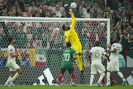 Saudi Arabia's goalkeeper Mohammed Al-Owais punches clear.