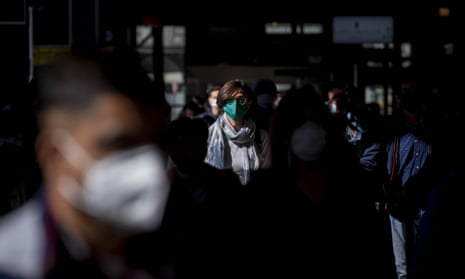 Rome commuters wearing face masks arrive at Termini station