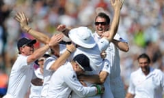 Andrew Flintoff, arms aloft, is mobbed by his England teammates