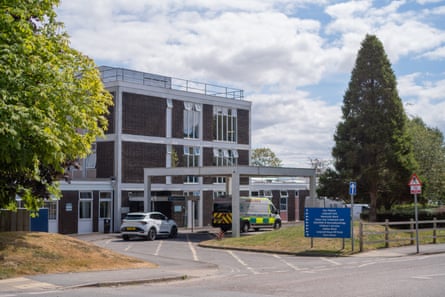 The exterior of a hospital building next to several trees.