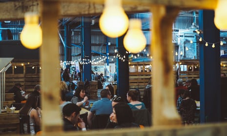 Diners in a warehouse at the Big Feed, Glasgow’s first regular street food party.