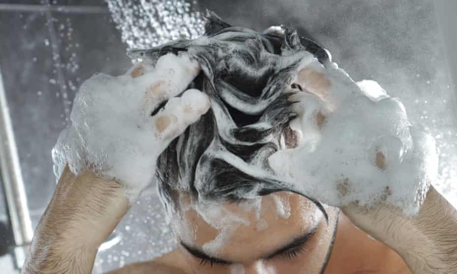 Man in shower washing hair