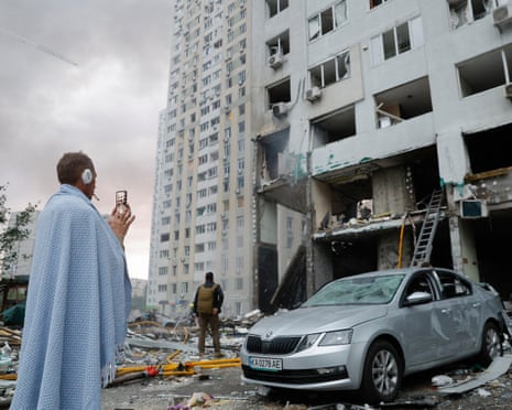 An injured local man reacts after a large-scale combined Russian attack on a residential area in Kyiv.