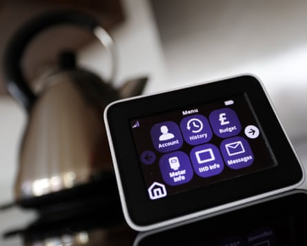 An energy smart meter on the sideboard of a kitchen in front of a metal kettle