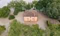 Italian country home amid floodwater, seen from above.