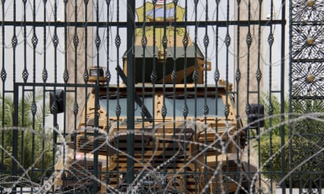 An armoured vehicle and razor wire block a side entrance to the Tunisian parliament in Tunis