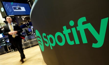 A trading post sports the Spotify logo on the floor of the New York Stock Exchange. Spotify, the No. 1 music streaming service which has drawn comparisons to Netflix, is about to find out how it plays on the stock market in an unusual IPO.