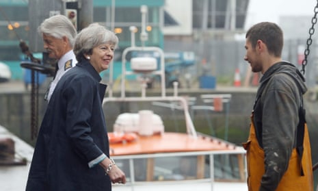 Theresa May meets Carl Hatton during a visit to Plymouth Fisheries this morning.