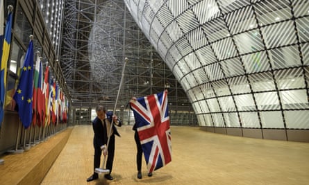 Officials remove the British flag from the Europa building in Brussels